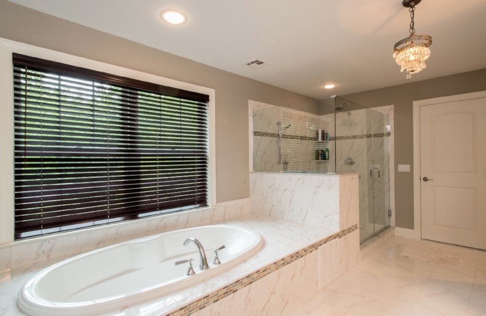 bathroom with tub and walk in show in custom home by gtg builders in central new jersey